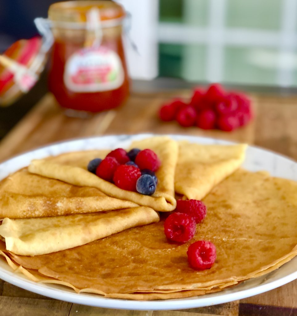 Russian crepes also known as Blinchiki's, with berries and jam.